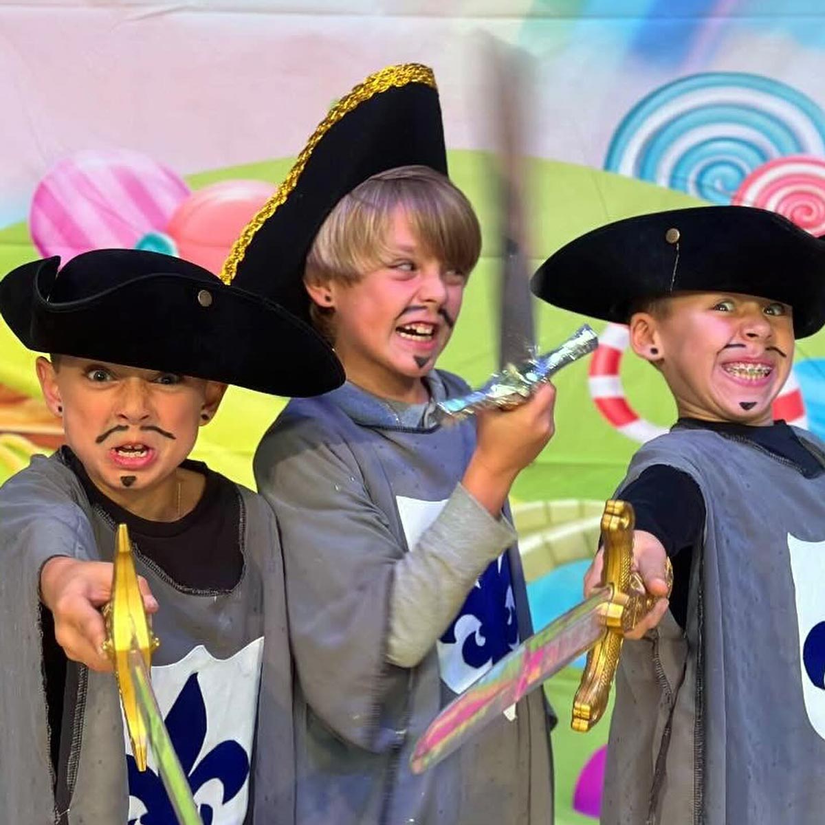 three boys play acting as muskateers